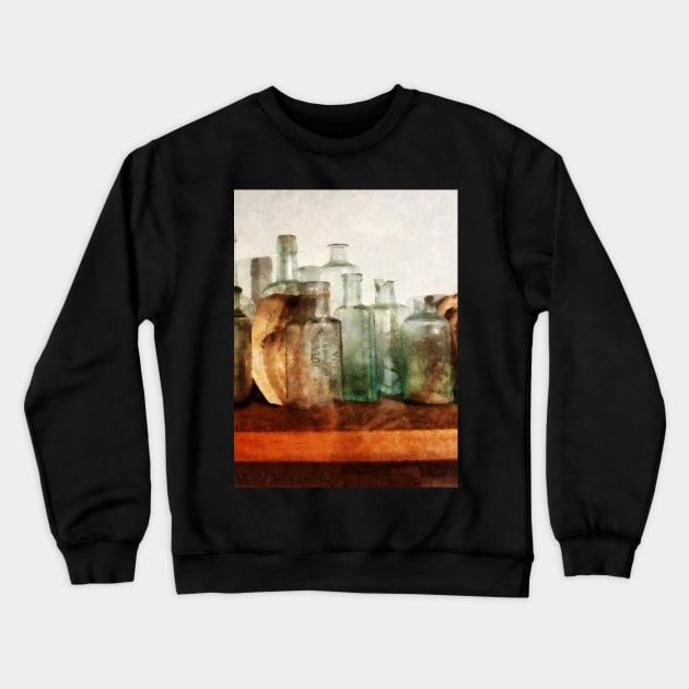 Row Of Medicine Bottles Crewneck Sweatshirt by SusanSavad